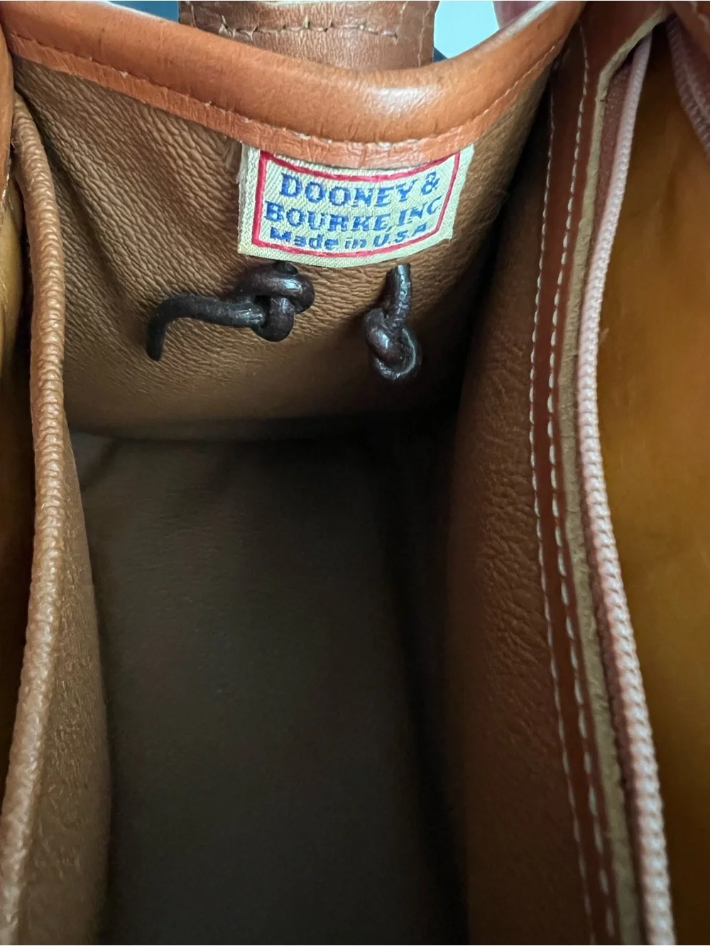 Dooney & Bourke VINTAGE black pebbled Leather satchel with British tan trim.